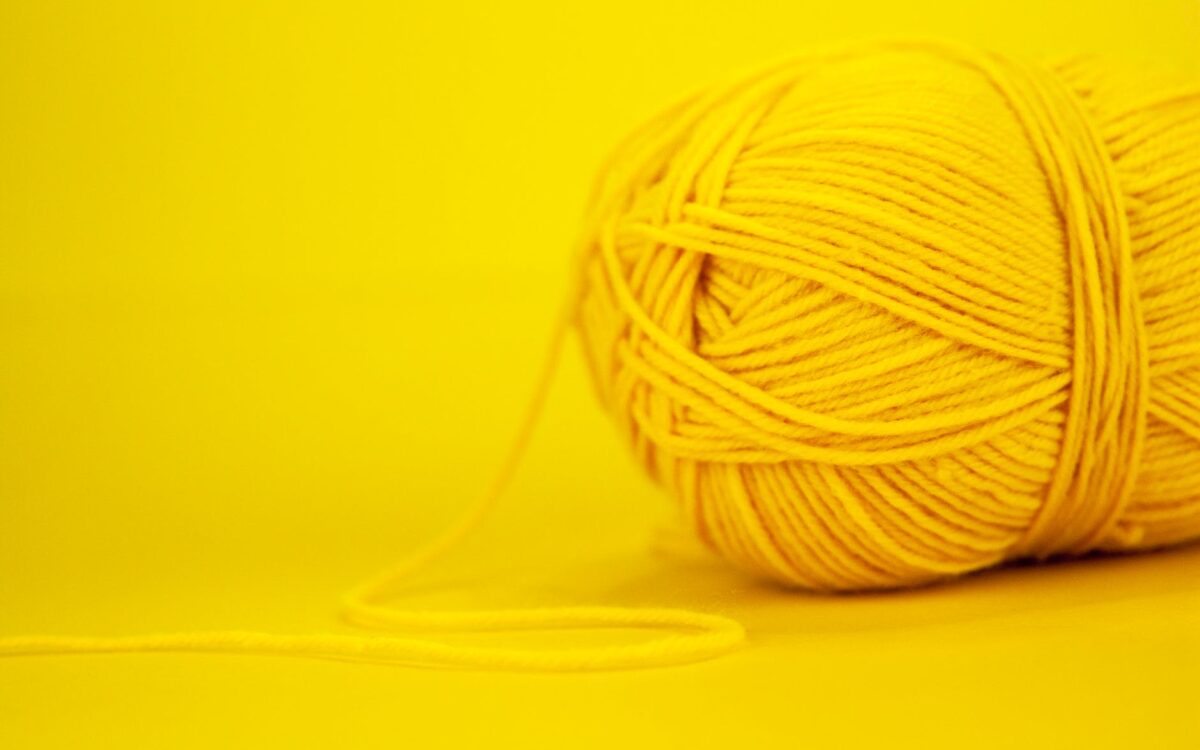 part of yarn on yellow background